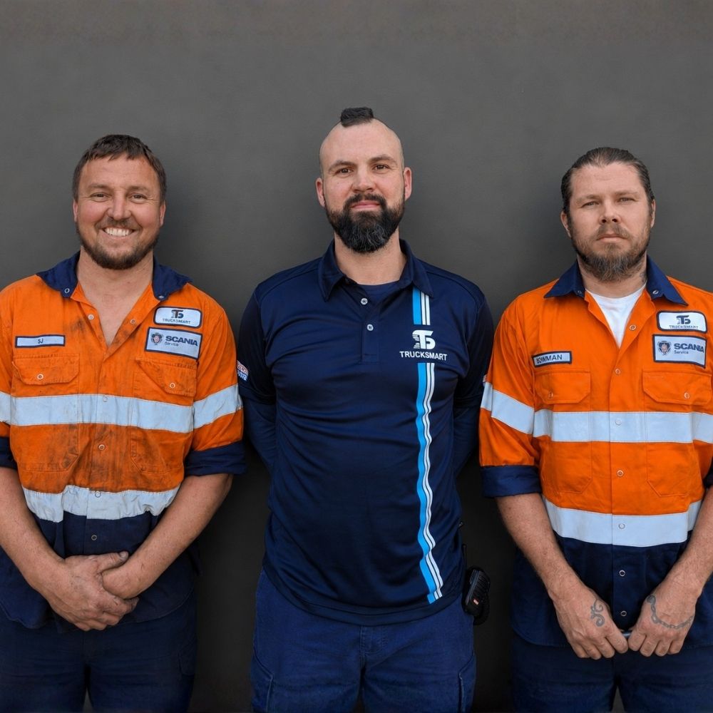 Trucksmart heavy vehicle service team standing together in branded workshop uniforms at Beresfield.